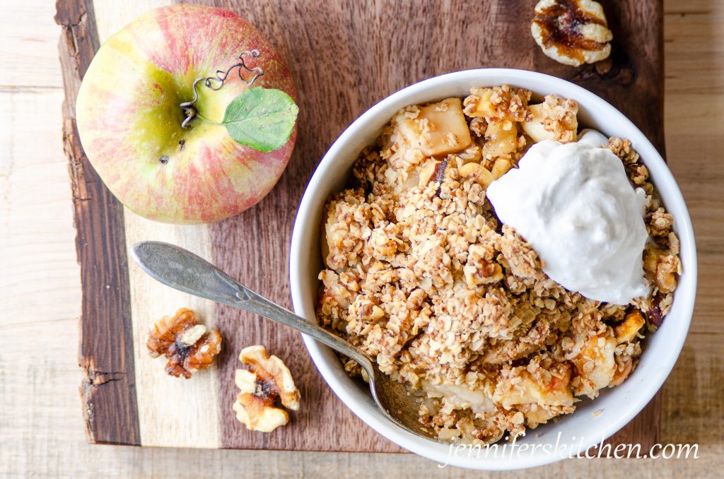 Sugar-Free, Gluten-Free 
Apple Crisp in a bowl with cream on top.