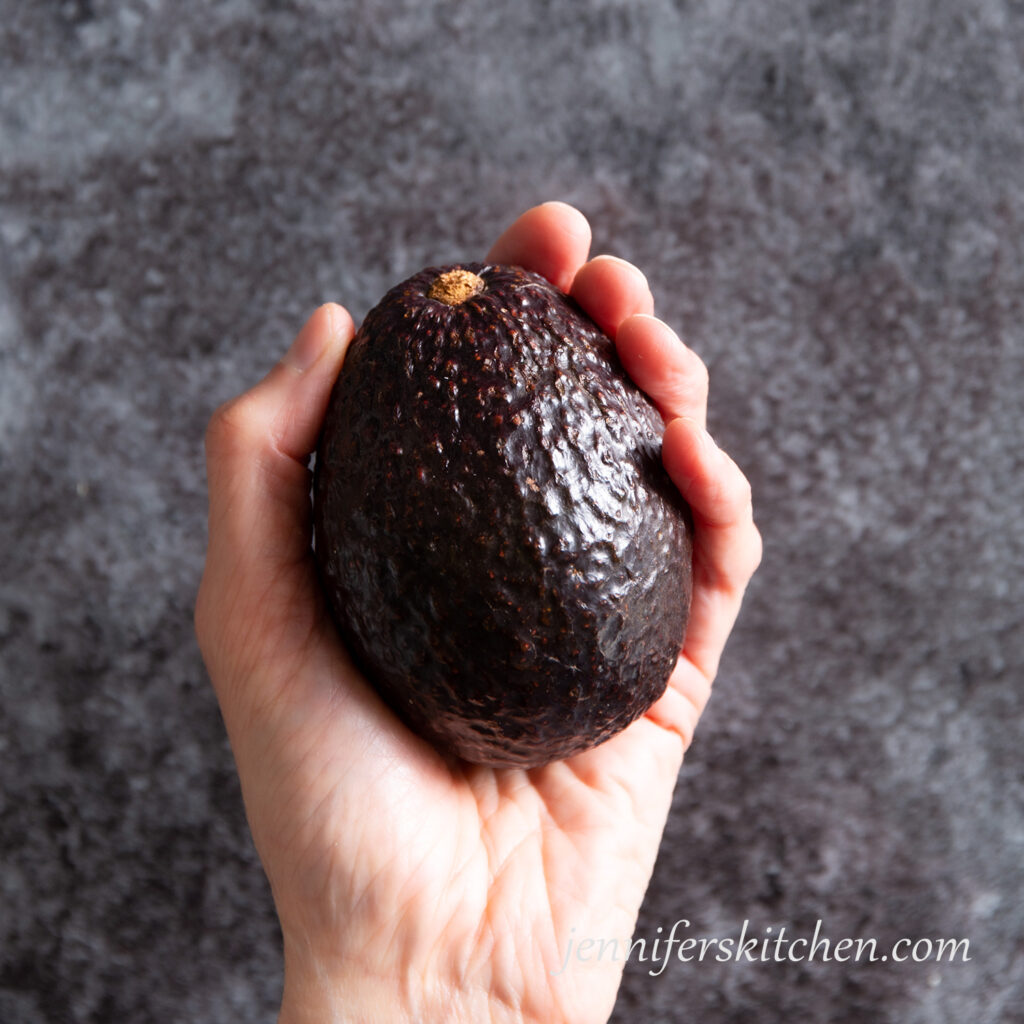 Holding an avocado ready to cut