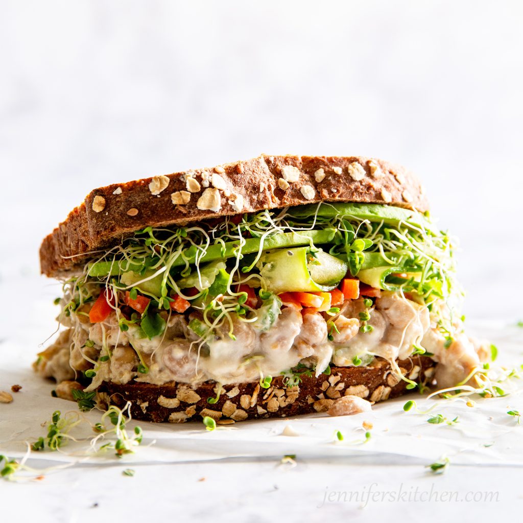 A delicious overflowing No-Mayo Vegan Chickpea Salad Sandwich.