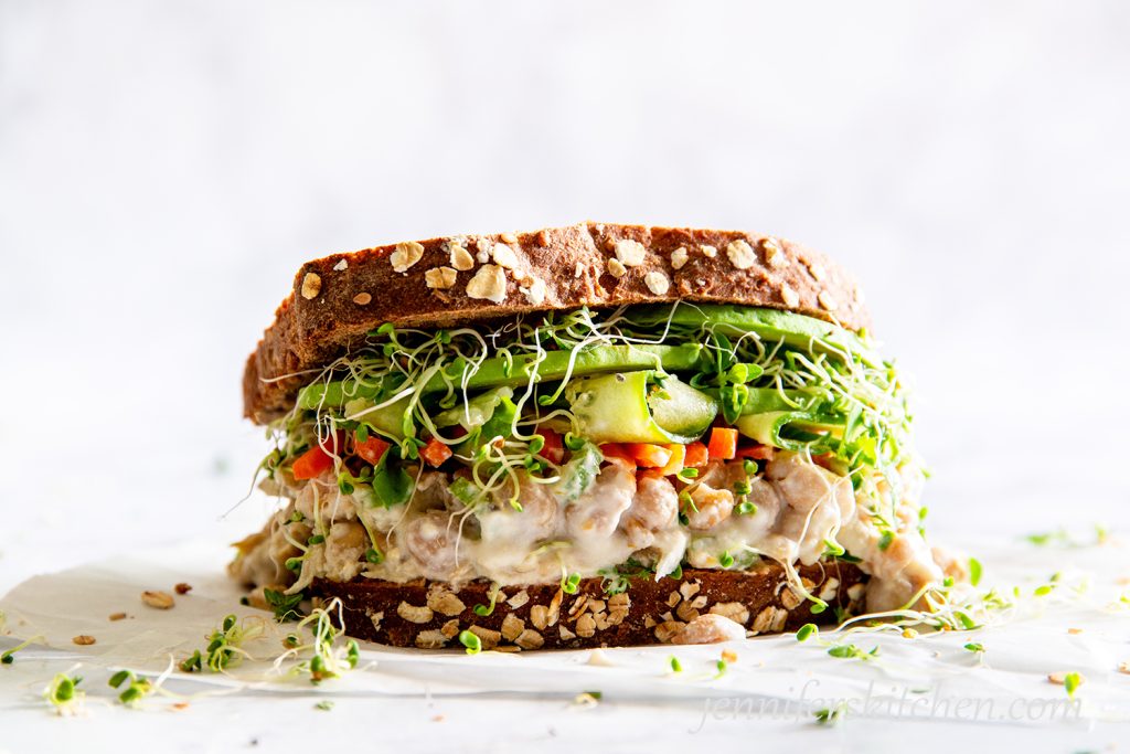 A delicious overflowing No-Mayo Vegan Chickpea Salad Sandwich.