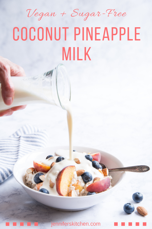 pouring Coconut Pineapple Milk onto cereal and fruit