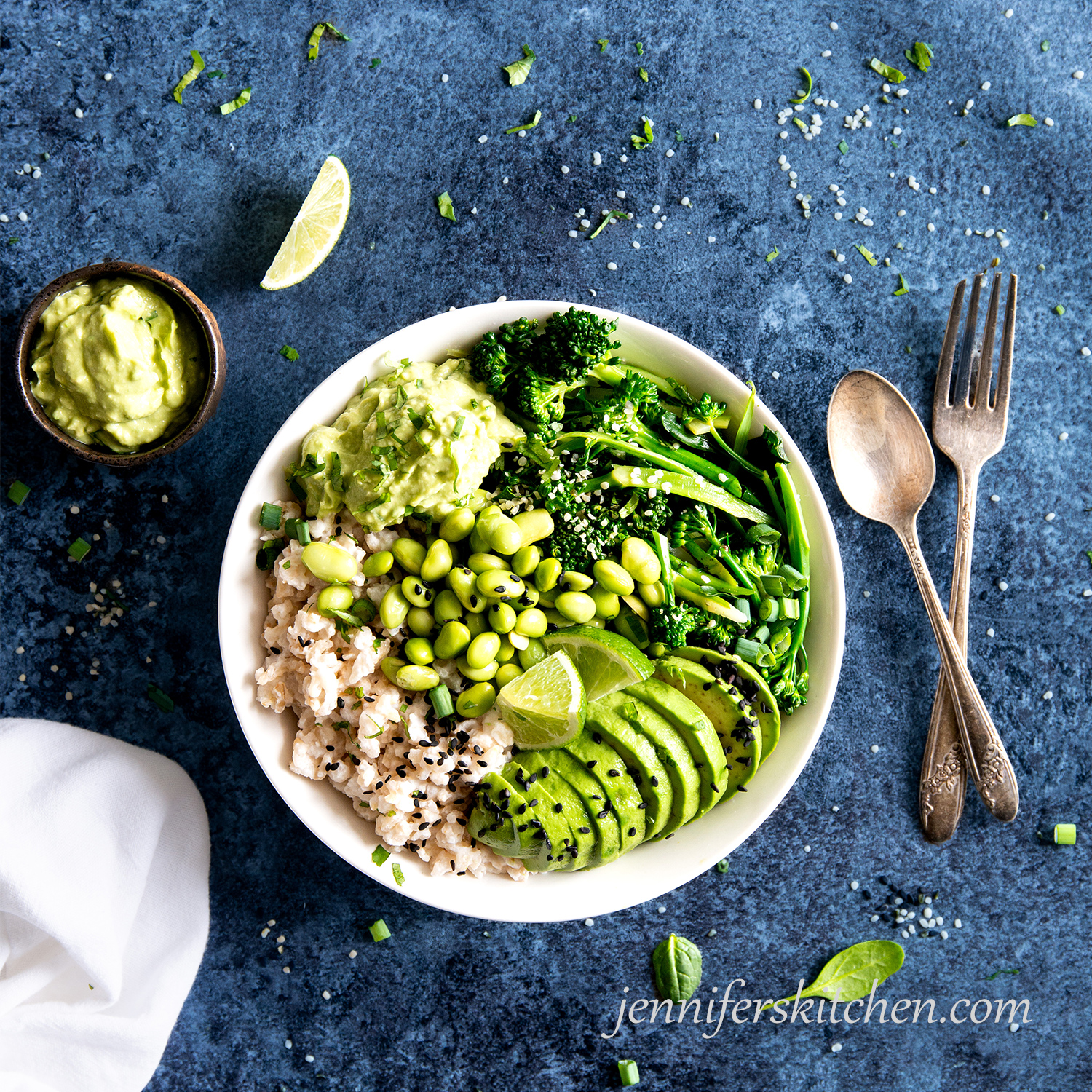 Coconut Rice Veggie Bowl with avocado sauce and limes