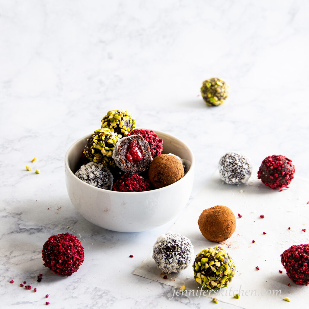 Fudgy Raspberry-Filled Cookies in a bowl with one opened and ready to eat!