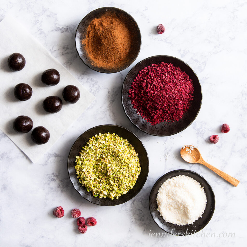 Fudgy Raspberry-Filled Cookies ready to be coated in pistachio, coconut, raspberries, or carob powder.