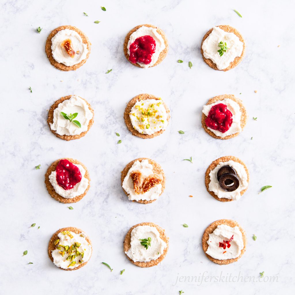 Oil-free, whole-grain oat crackers, topped with vegan almond cheese, sugar-free raspberry jam, figs, and pistachios.