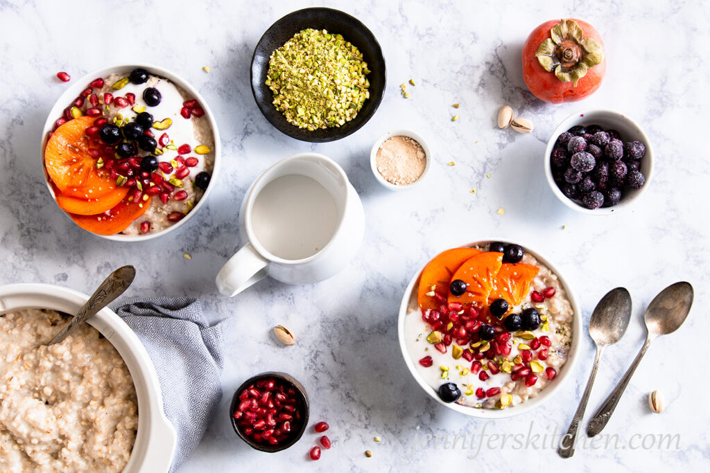 Crockpot/slow cooker oats for breakfast topped with blueberries, pomegranate, persimmon, and pistachios.