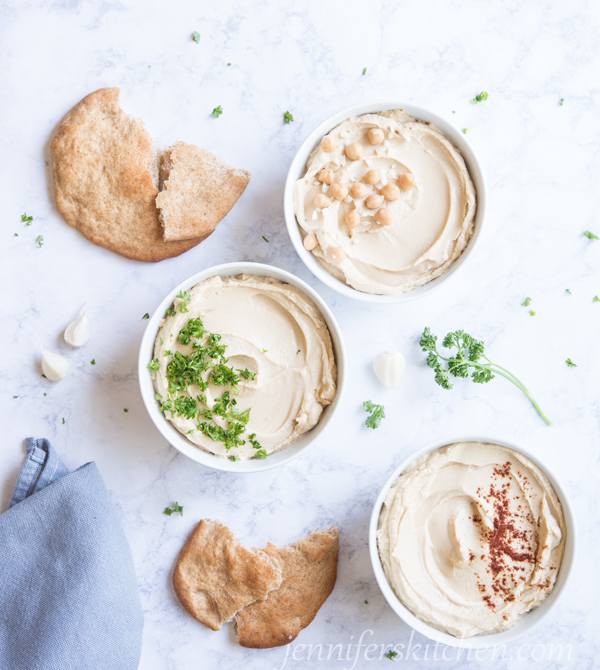 3 bowl of healthy oil-free hummus with flat bread for dipping