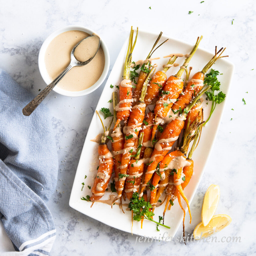 Roasted carrots drizzled with Tangy Tahini Sauce