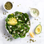Spinach Avocado Salad with pumpkins seeds, avocado, and fresh lemon