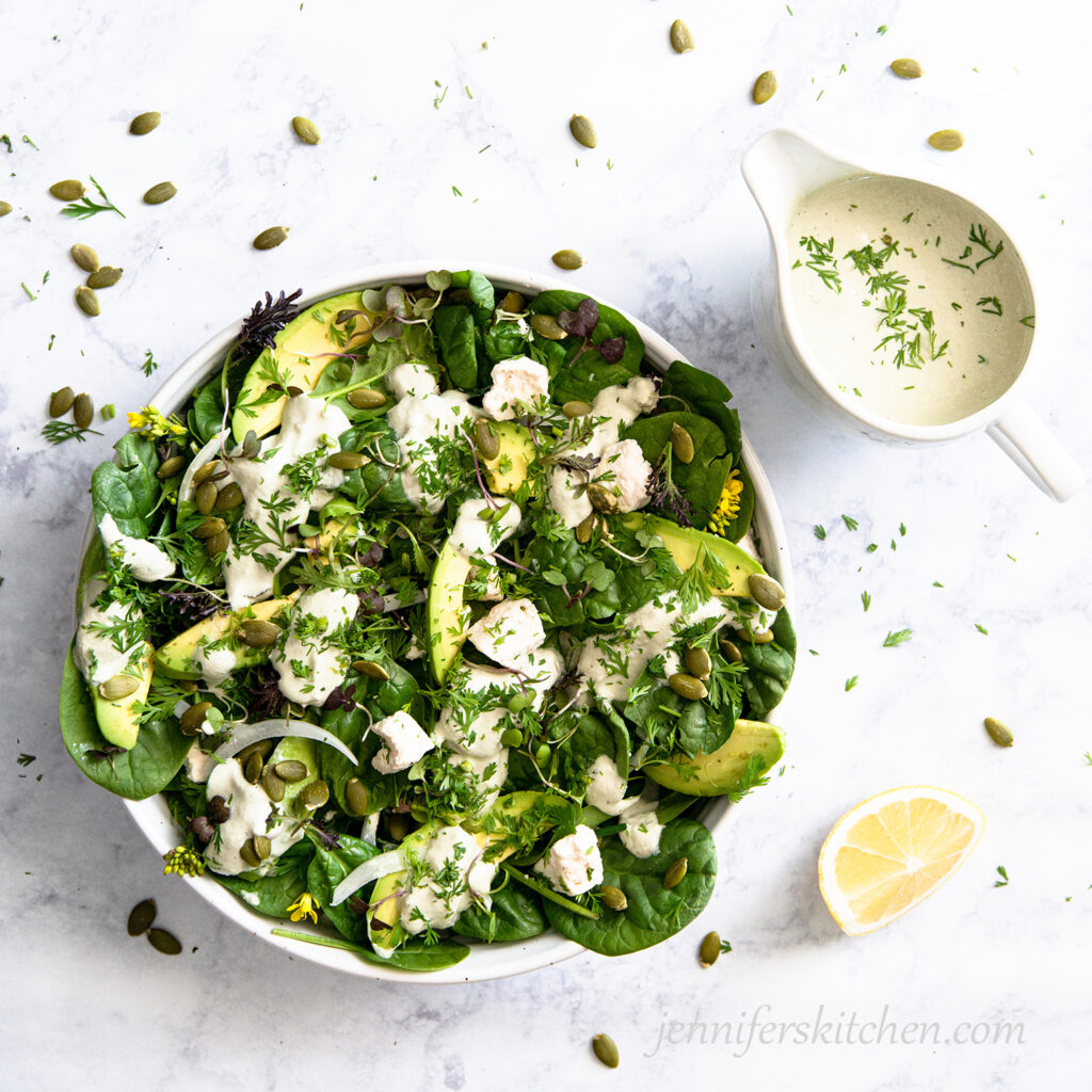 Spinach Avocado Salad with topped with Pumpkin Seed Dressing