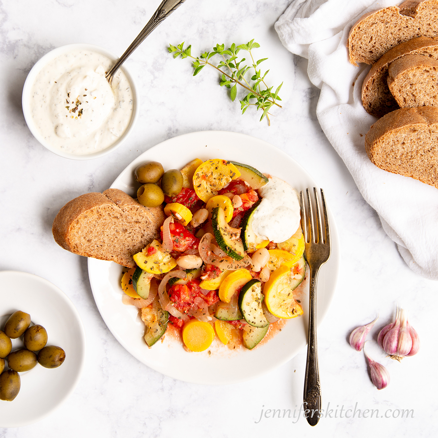 Summer Squash Sauté served with cashew dressing and whole-grain bread.